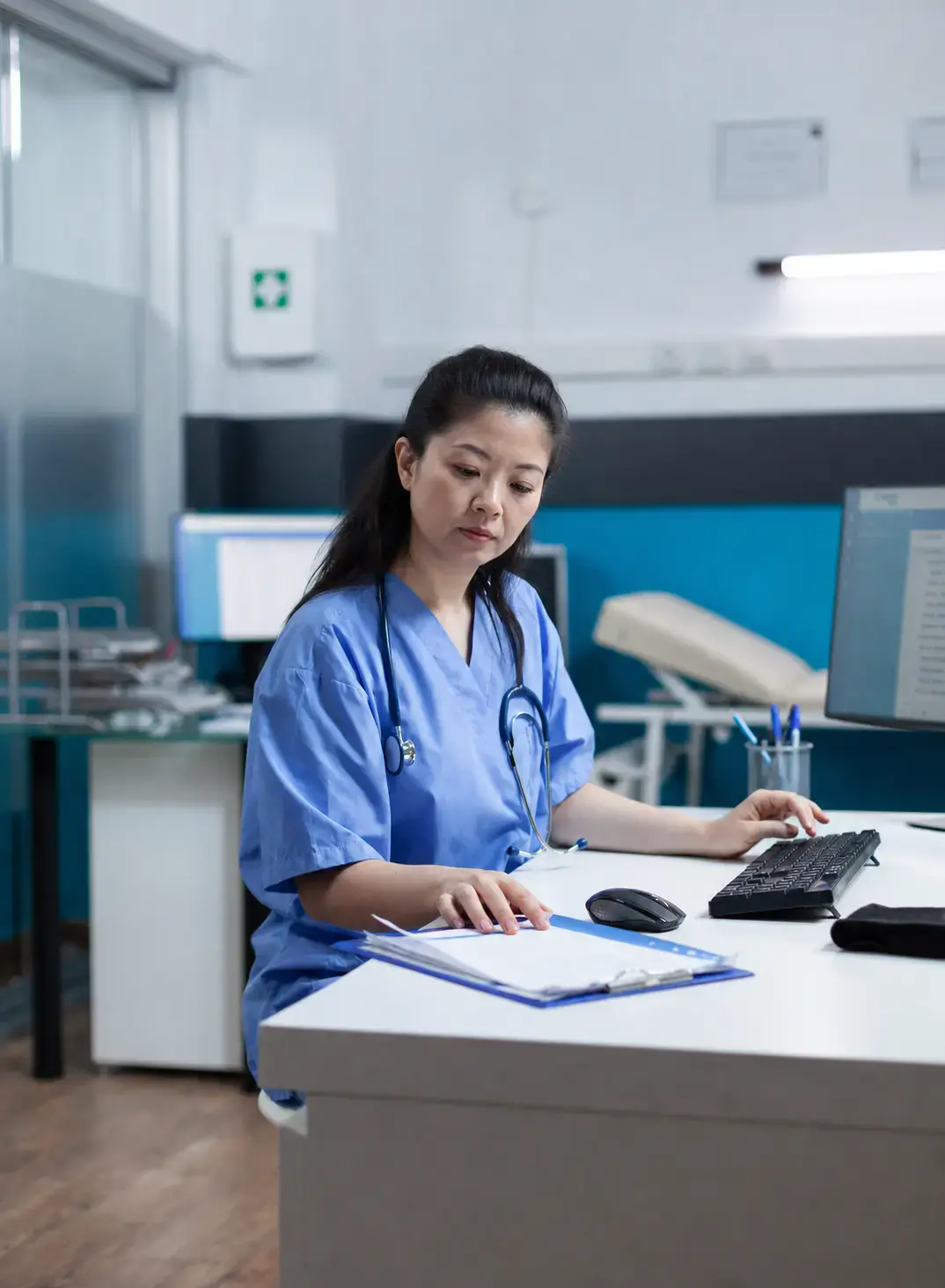A clinician working through a patient's paperwork.