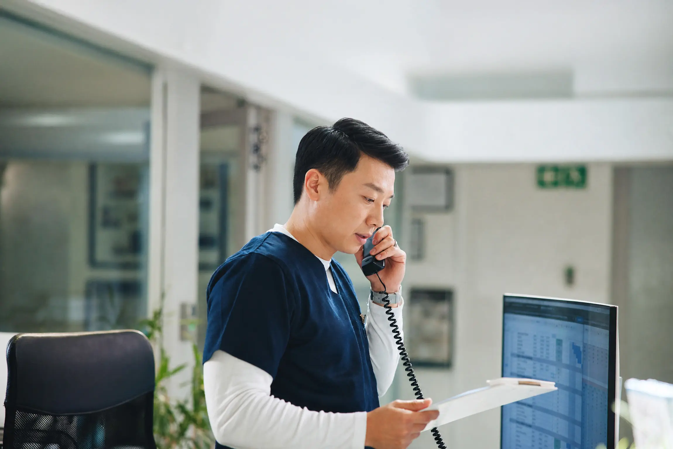 A member of the team taking a call at the front desk.