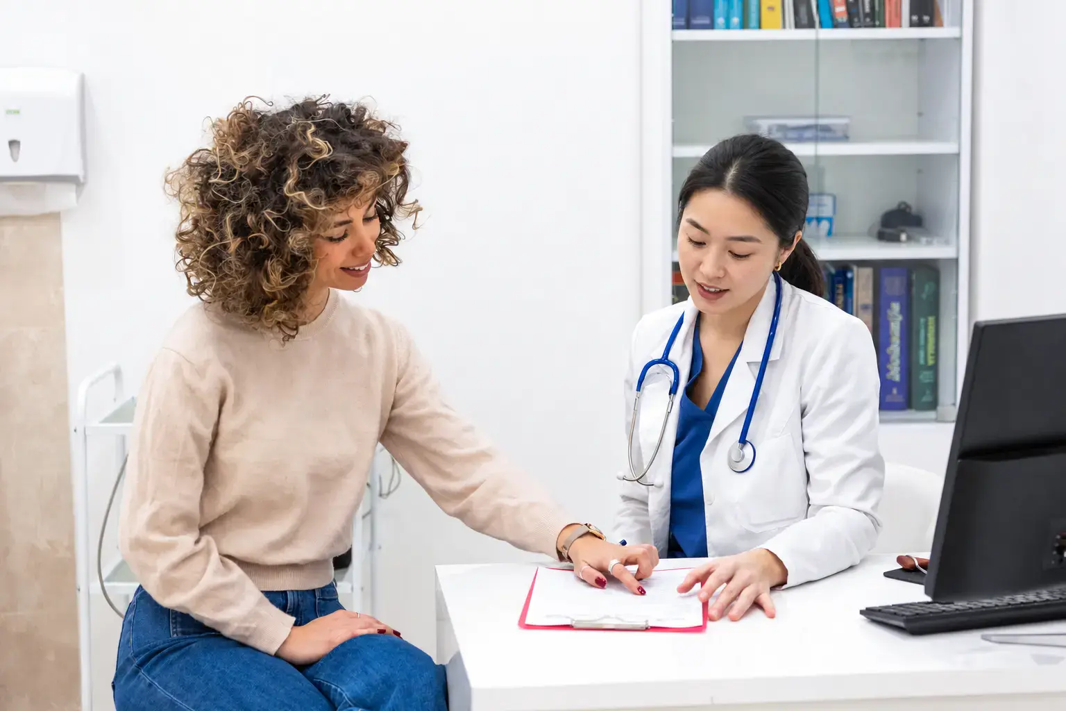 A physician talking a patient through her report.