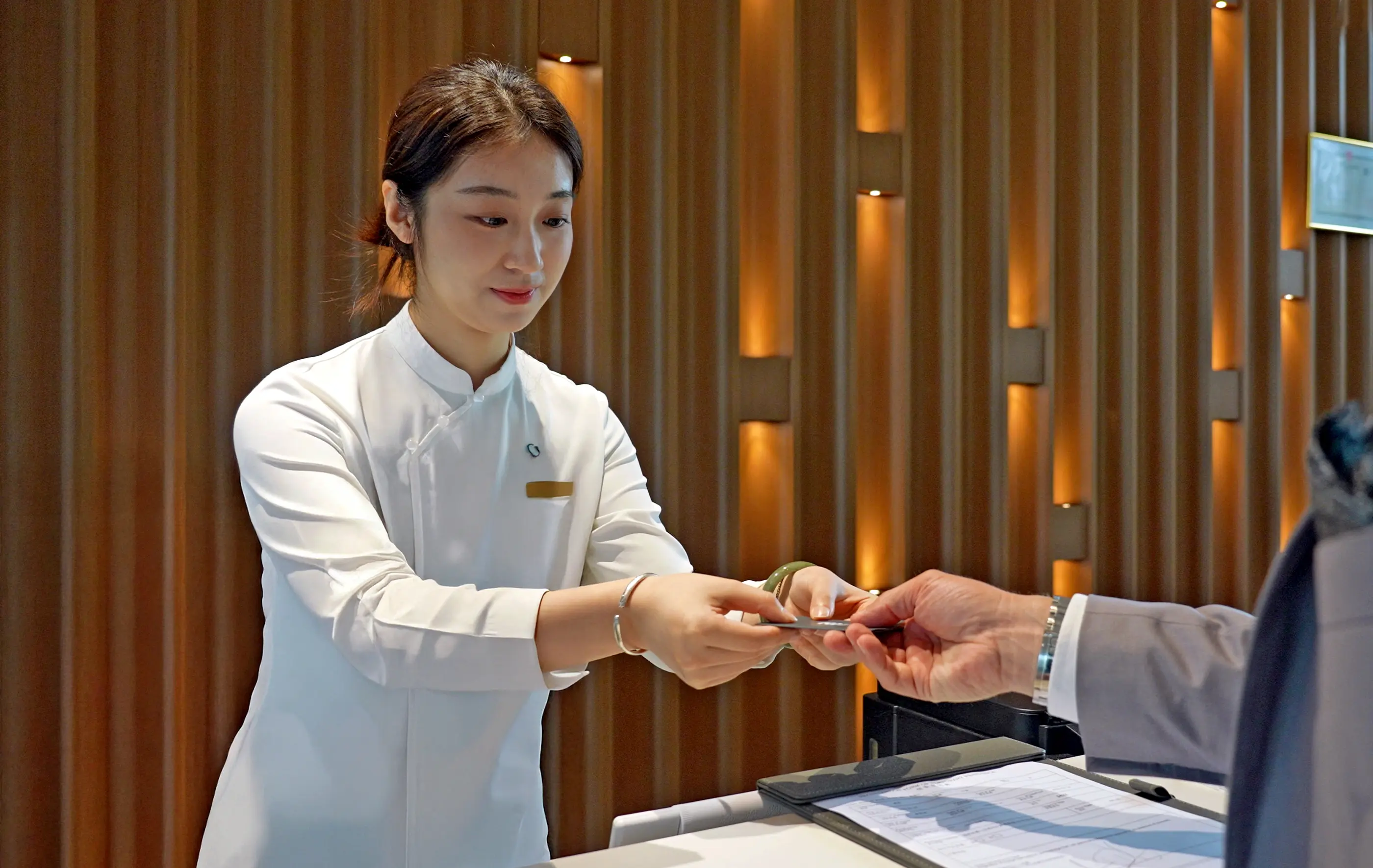 A guest settling their visit at the reception desk.