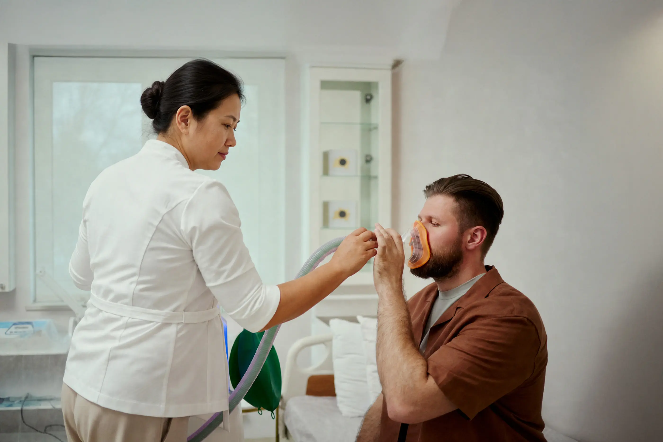 A clinician guiding a patient through pulmonary function testing.