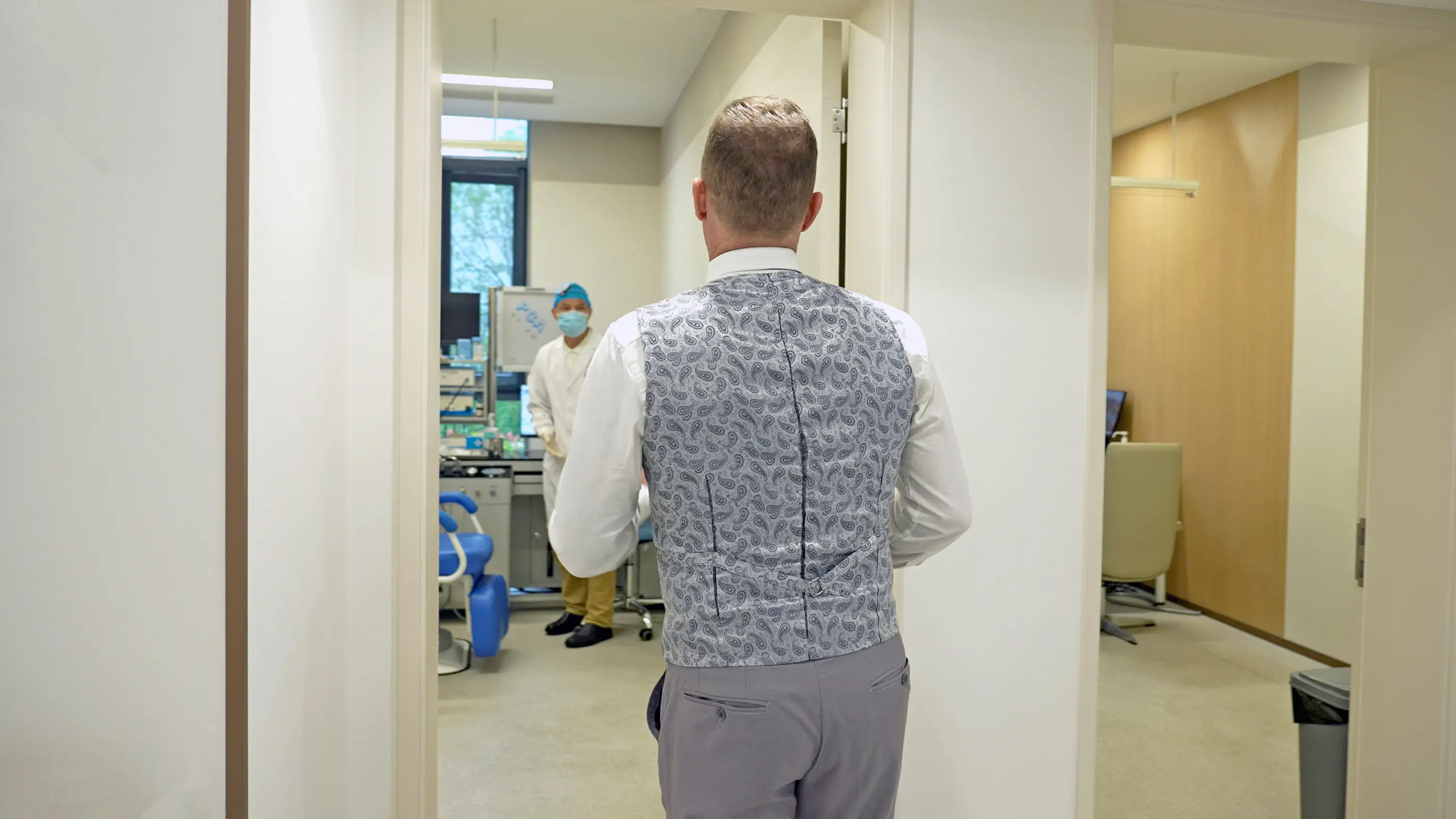 A guest being shown into a treatment room at Shanghai International Medical Center.
