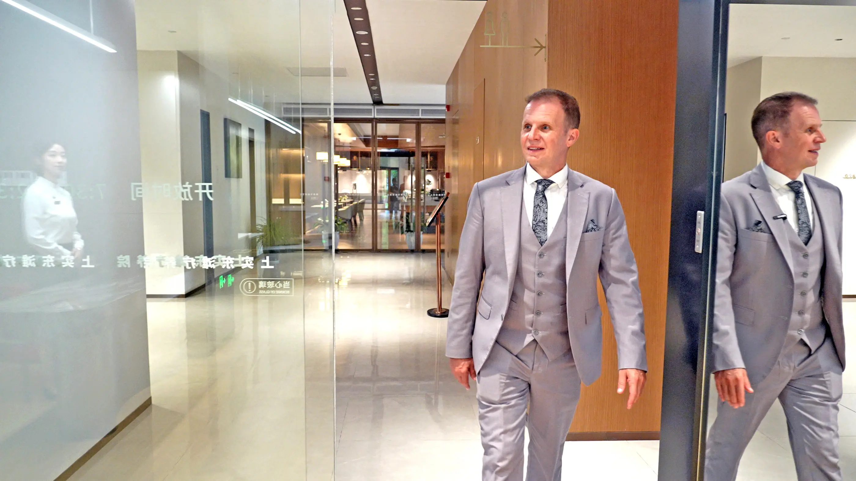 A guest walking through the warm corridors of Shanghai International Medical Center.