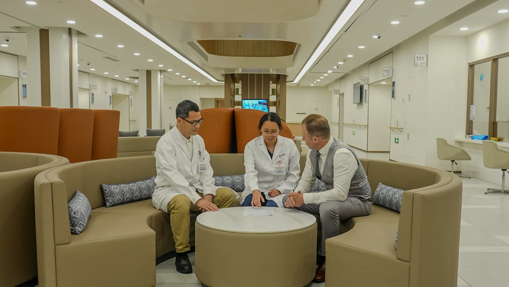 Two doctors explaining assessment results to a patient in person.