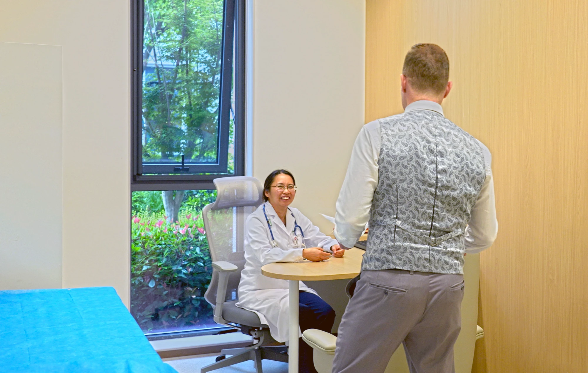 A physician in consultation with a patient.
